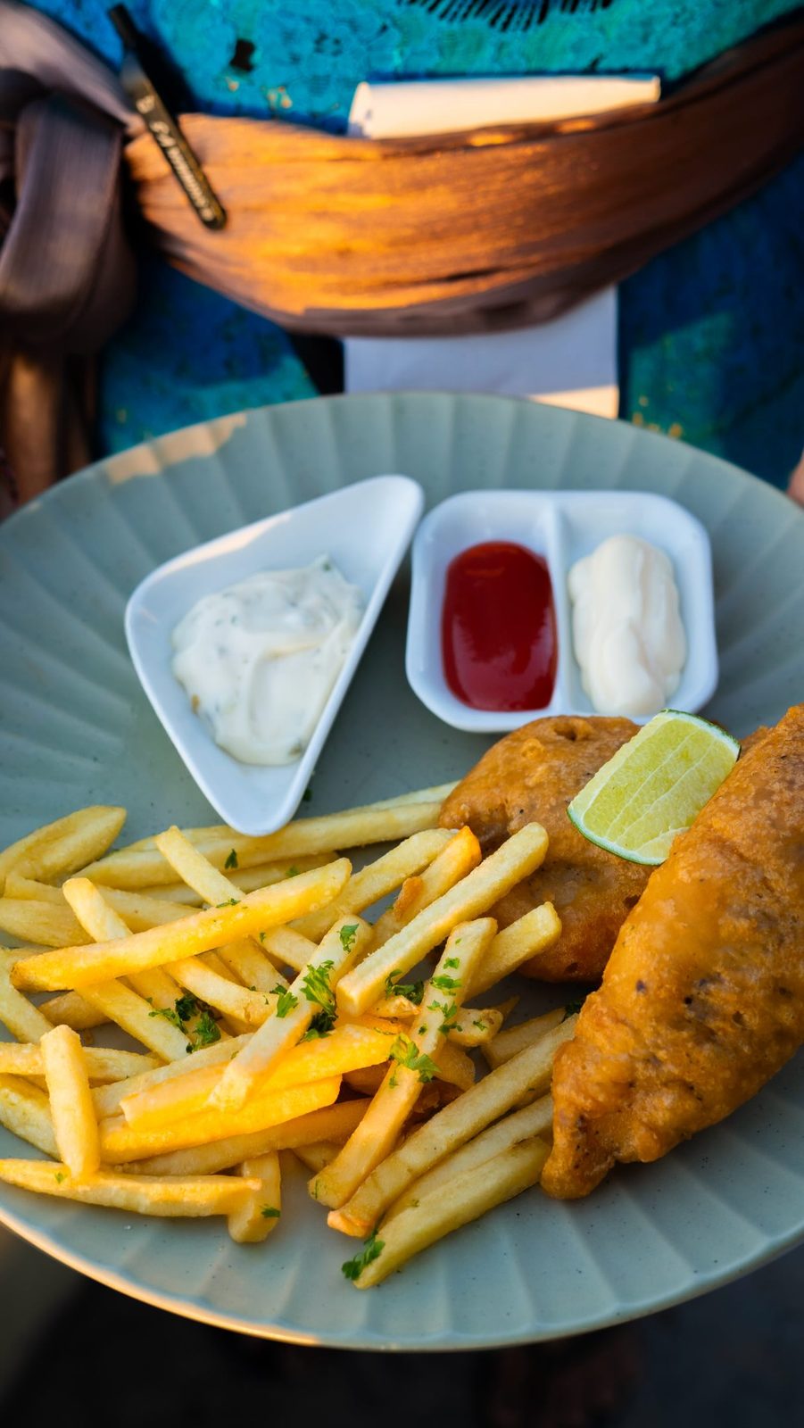 Fish and chips with tartar sauce, ketchup and mayo